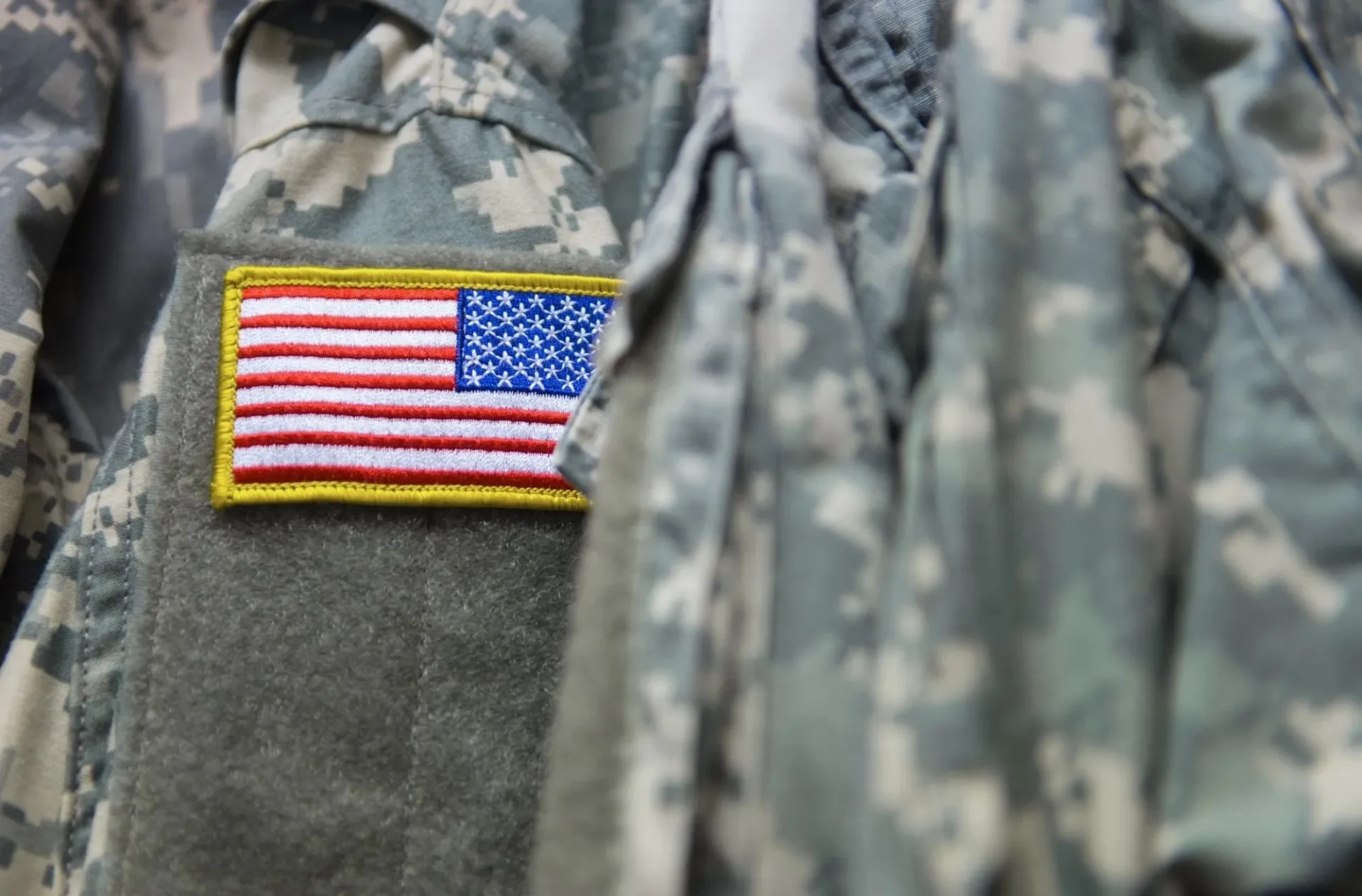 A close up of the american flag patch on a uniform.